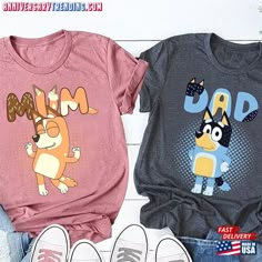 two t - shirts with cartoon characters on them, one is pink and the other is grey