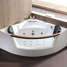 a white bath tub sitting on top of a counter next to a wooden door and window