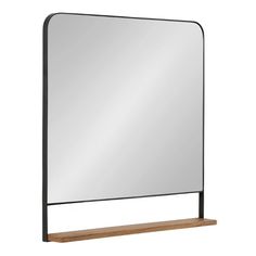 a large mirror sitting on top of a wooden shelf