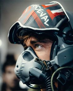 a close up of a person wearing a helmet and goggles with the words naval on it