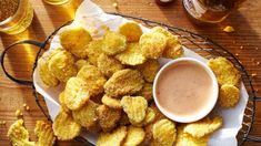 a plate full of fried food next to some beer