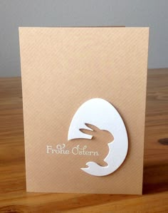 a brown card with a white rabbit on it