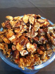 a blue bowl filled with nuts on top of a table