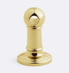 a golden door knob on a white background with the top part of it turned down