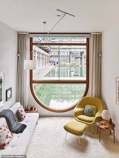 a living room filled with furniture and a large window