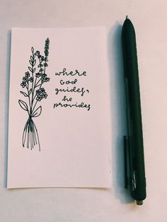 a notepad with a pen next to it and a drawing of a lavender plant