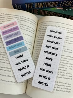 two bookmarks sitting on top of an open book