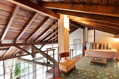 a bedroom with wooden ceilings and green carpet