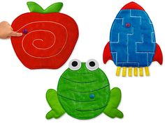 a hand is pointing at two different shaped objects, one with a snail and the other an apple