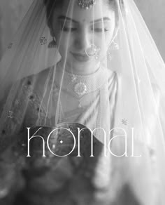 a black and white photo of a woman wearing a bridal veil with the word komal on it