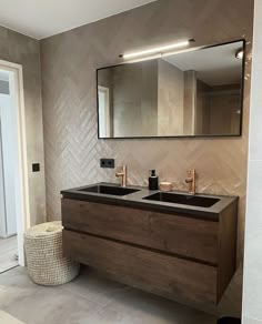 a bathroom with two sinks and a large mirror