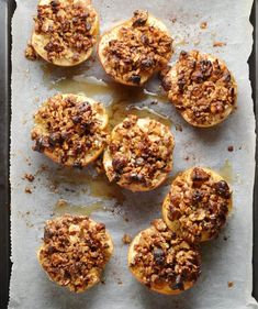 baked apples with crumbled toppings on a baking sheet