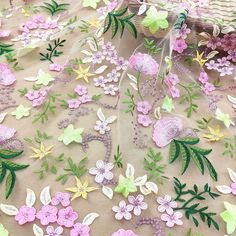 the fabric is covered with flowers and leaves