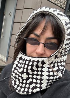 a woman wearing sunglasses and a knitted hat