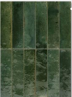 green tiles are lined up on the wall