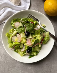 a salad with radishes and other vegetables in a white bowl on a table