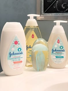 three bottles of johnson's hand sanitizers on a bathroom counter