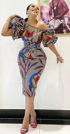 African print dress  Asymmetric neckline  Short sleeve  Knee length  Puff sleeve  Zipper on the back  Fully lined Ankara Short Gown Styles, Dress Ankara, African Dresses Modern