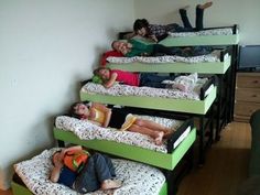 several children laying on bunk beds in a room