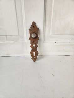 an old wooden door handle on a white wall