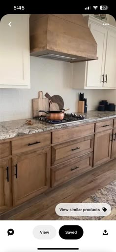 a kitchen with wooden cabinets and marble counter tops is viewed on an iphone app that displays the same image