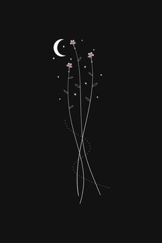 the back side of a black phone case with flowers and a crescent on it, against a dark background