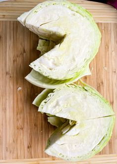 two wedges of cabbage sitting on top of a cutting board