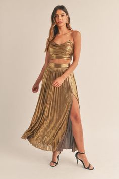 This Isabella Skirt Set features a stunning foil lamay fabric, with the classic two-piece set design. It is perfect for high fashion occasions and provides a stylish look. The maxi split skirt has a beautiful side split, giving it a sophisticated, contemporary edge. 96% Polyester 4% Spandex Chic Metallic Flowy Skirt, Chic Flowy Metallic Skirt, Flowy Maxi Dress For Night Out, Elegant Metallic Long Skirt, Glamorous Evening Maxi Skirt For Summer, Chic Metallic Skirt For Formal Occasions, Chic Formal Metallic Skirt, Elegant Metallic Midi Skirt, Flowy Maxi Skirt For Night Out