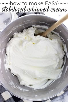 a bowl filled with whipped cream on top of a checkered table cloth