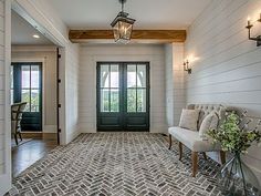 an entry way with two doors and a table