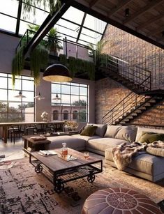 a living room filled with lots of furniture and plants on top of the walls in front of large windows