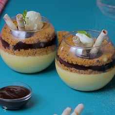 two desserts are sitting on a blue table