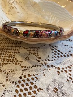 This enamel bangle features a striking red and gold design with butterflies. Despite showing signs of wear on the inner surface, the unique pattern and vibrant colours make it a standout accessory. Perfect for adding a touch of personality to any ensemble, this bracelet is a must-have for those who appreciate bold, eye-catching jewellery. The diameter is about 2.5" Red Enamel Bangle Jewelry, Red Enamel Bangle Bracelets, Luxury Vintage Red Bangle, Red Enamel Bangle, Handmade Vintage Enamel Bangle, Vintage Bangle Bracelets, Bakelite Bangles, Enamel Bangle, Bangles Bracelets