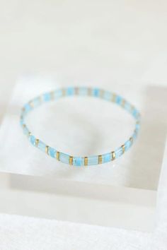 Add a touch of coastal elegance to your bracelet aesthetic with our handmade "Water" tila bracelets. The colorful delicate glass beads and stretchy design make this bracelet perfect for everyday wear or special occasions. All of our tila bracelets are designed to layer and stack, creating your own personal jewelry style.