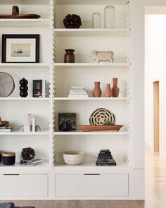 a white bookcase filled with lots of books