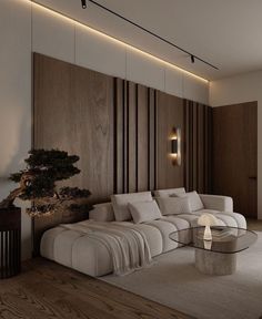 a living room with a couch, coffee table and wall lights on the walls behind it