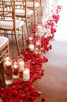 the aisle is lined with candles and rose petals