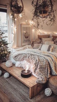 a bedroom decorated for christmas with lights and decorations on the wall, bedding in neutral colors