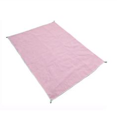 a pink blanket is laying on the ground