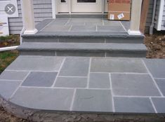 the steps are made out of stone and have been painted gray with white trims