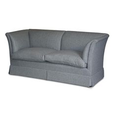 a gray couch with two pillows on it's back and the seat folded down