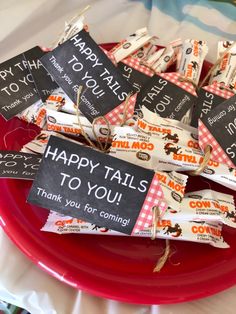 candy bar wrappers with happy tails to you on them sitting on a red plate