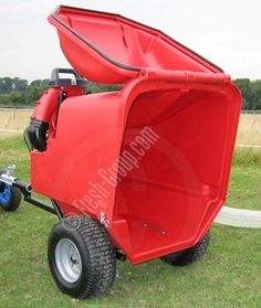 a red wagon with wheels on the grass