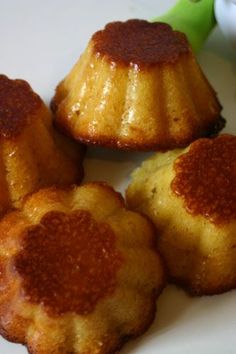 four small cakes sitting on top of a white plate