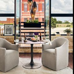 two chairs and a table in front of a window