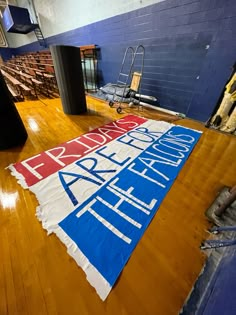 a large sign is laying on the floor in an empty room with hard wood floors