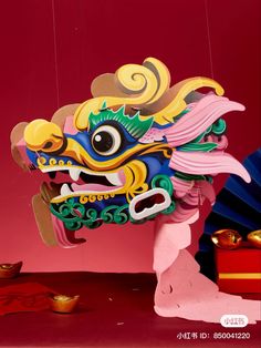 a colorful dragon statue hanging from the side of a red wall next to other items