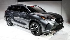 a silver suv is on display at an auto show