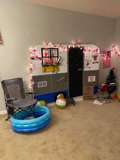 a room decorated for christmas with an inflatable pool, basketball hoop and other decorations