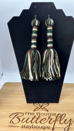 These Camouflage Tassel Earrings are not just accessories; they're expressions of your style and individuality. Whether you pair them with a casual outfit to add a touch of flair or wear them to a special occasion to make a statement, they are sure to turn heads and spark conversations. These earrings dangle up to 5 inches from the earlobe.  These unique earrings are the perfect accessory to make a bold fashion statement and stand out in any crowd. 🌿 Key Features: 🎨 Eye-catching Camouflage Design: Our tassel earrings feature a trendy camouflage pattern that's both edgy and elegant. These earrings are designed for the fashion-forward individual who wants to embrace a style that's uniquely their own. ✨ Dramatic Length: These earrings boast an impressive length that draws attention and make Luxury Tassel Jewelry, Drop Tassle Earrings, Cheap Green Dangle Tassel Earrings, Party Tassel Dangle Earrings, Cheap Dangle Tassel Jewelry, Cheap Statement Jewelry With Tassels, Cheap Trendy Tassel Earrings, Cheap Statement Tassel Earrings With Colorful Beads, Cheap Statement Tassel Earrings For Party